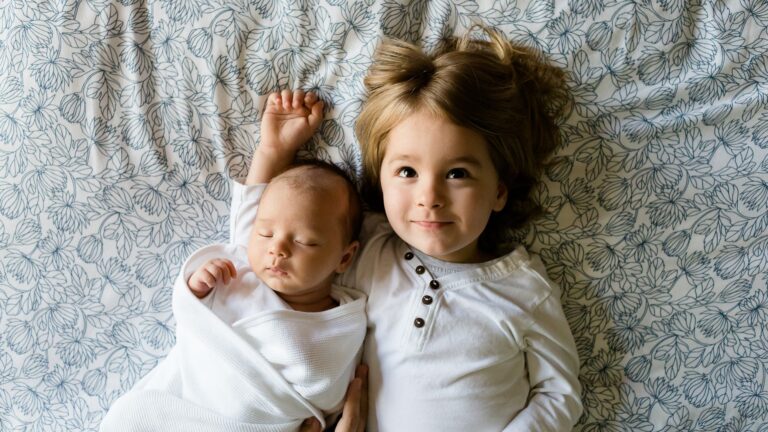 newborn baby and sister